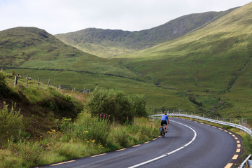 Connemara (Ireland), - July 20, 2016: Cyclist on Connemara road, Co. Galway, Ireland
