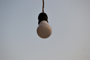 Light bulb in the sky background