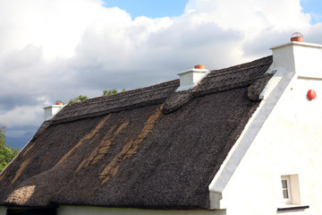 Connemara (Ireland), - July 20, 2016: Traditional Old Irish Cottage with a thatched roof in...