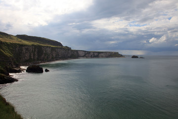 Fototapeta premium Ballintoy (Ireland), - July 25, 2016: Coastal scenery near Carrick a Rede along the causeway coast, Co. Antrim, Ireland