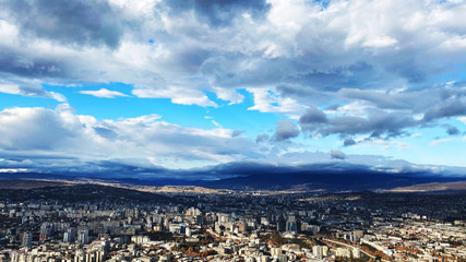 TBILISI, GEORGIA  DECEMBER 14, 2019:  Beautiful aerial view of the central part of city    and blue sky in Tbilisi, Georgia © Victoria Key