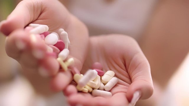 woman Holding pills in Hands, Selective focus