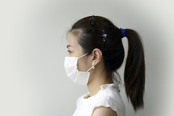 A woman wearing a protection mask for a serious fight against the virus.  Protection against virus, infection, exhaust and industrial emissions.