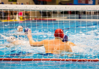 Water-polo match with goalkeeper in gate