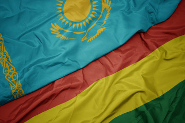 waving colorful flag of bolivia and national flag of kazakhstan.