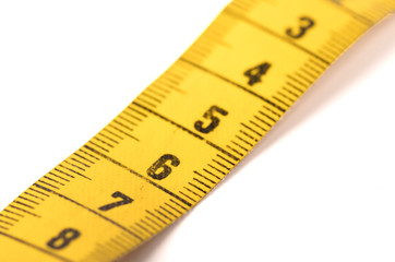 Close-up of a yellow measuring tape isolated on white - 6