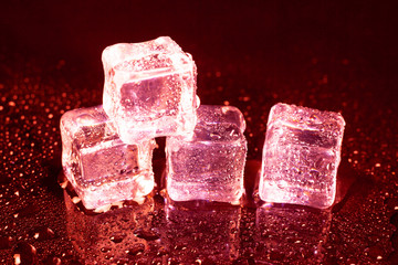 ice cubes on a reflections red light.
