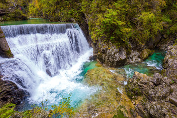 Fototapeta na wymiar Rumbling waterfall on river