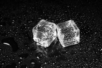 ice cubes on black table background.