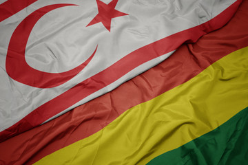 waving colorful flag of bolivia and national flag of northern cyprus.