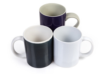 Three empty cups different colors and sizes on white background