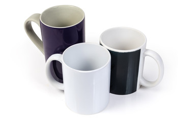 Three empty cups different colors and sizes on white background