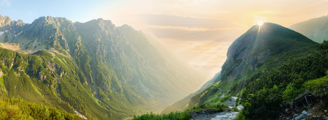 Deep mountain valley in morning sunlight, panoramic view - Powered by Adobe