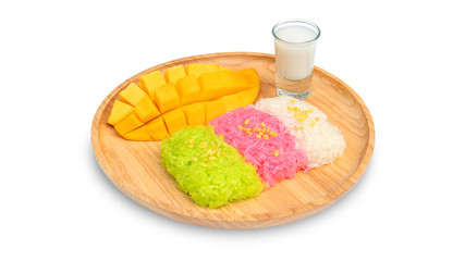 Three colors of sticky rice and ripe mango (Thai dessert) on a white background.
