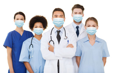 health, medicine and pandemic concept - doctors and nurses wearing protective medical masks on...