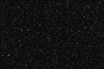 Vector realistic black gold glitter particles background- isolated black shiny confetti and glitter sparkling texture. Star dust sparks in explosion on transparent background.