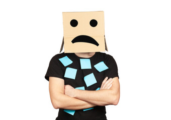 Upset employee with a box on his head, stress and problems in the office.