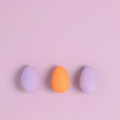 Fototapeta na wymiar Layout of easter eggs on a purple pastel background. Holiday concept.