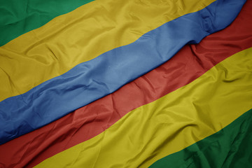 waving colorful flag of bolivia and national flag of gabon.