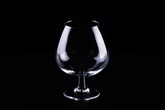 Empty transparent glass for cognac on a black background