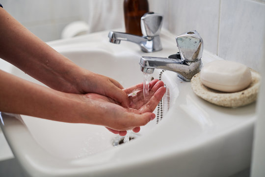 Photo of someone washing their hands , protecting themselves from the coronavirus Covid-19 spreading - Powered by Adobe
