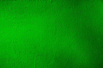 A grungy background of poisonous green with dimming. Venomously green uneven surface for design and text.