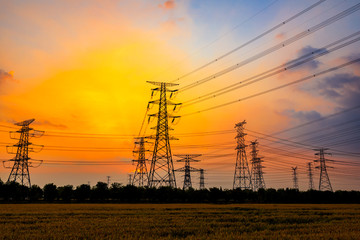 Industrial high voltage electricity tower and beautiful nature landscape at summer sunset