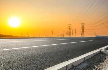 Asia empty asphalt road and power tower nature landscape at summer sunset
