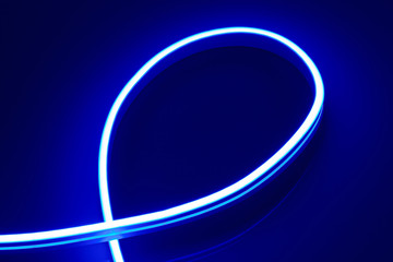 Flexible blue LED neon strip on black background