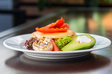 Vegetarian pancakes with grilled vegetables. Mushrooms, peppers and avocados. Decorated with grapefruit and salad