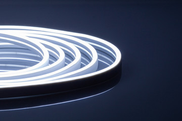 Flexible cold white LED neon strip on black background