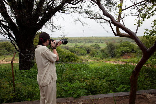 a photographer takes pictures from the observation sites at Ngandu Safari Lodge, Namibia, Africa