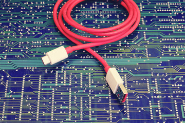 Red usb wire against electronic circuit board