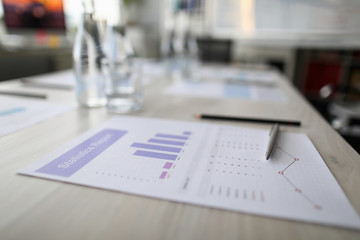 Close-up of statistics paper and silver pen laying on office desktop. Analyzing and gathering statistical data. Growth charts. Business and financial report concept