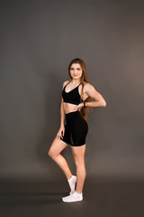 Fototapeta na wymiar Fitness girl on a dark background