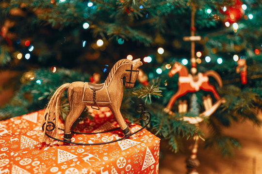 Toy horse decorations underneath a Christmas tree