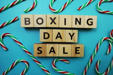Boxing Day Sale alphabet letter with candy cane decoration on blue background