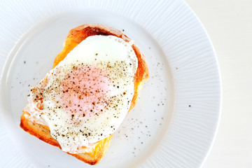 Egg cheese toast on white plate