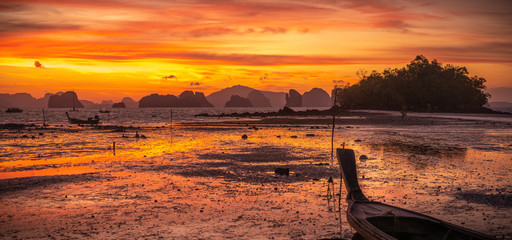 Bloody sunrise with long tail boat at Koh Yao Noi, Thailand