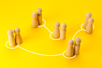 Obraz premium Concept of infidelity and betrayal (treason) in family or married couple. Wooden figures with lines as symbol of the relationship between man and woman on yellow background.