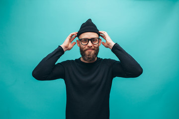 Handsome american hipster guy with beard wearing casual beanie and black longsleeve shirt with space for your logo or design. Mockup for print