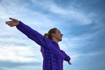 Happy girl with arms outstretched.