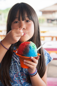 A girl holding shave ice in Hawai'i.  Being Happy