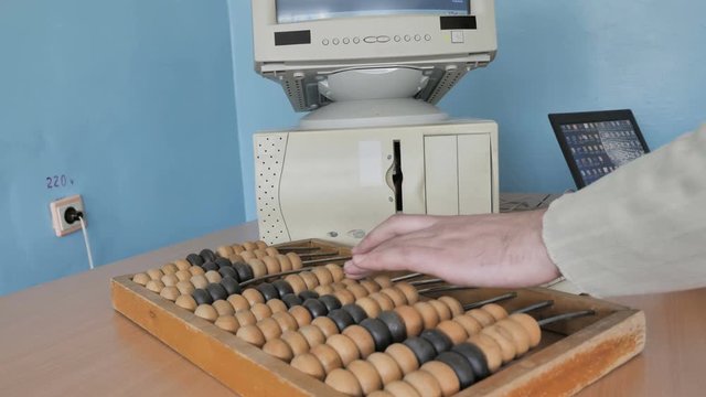  Accountant Working With Computer And Abacus Calculator 