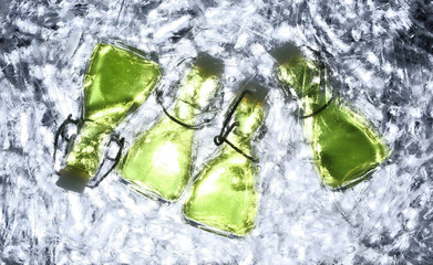 Lots of absinthe bottles in ice bucket.under table view.green alcohol.Abstract background.