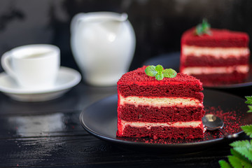 Cake Red velvet on two white plates, two servings. On a black background. Birthday, holidays,...