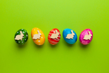 Bright easter eggs with bunny (rabbit) on green background. Retro colorful spring decoration.