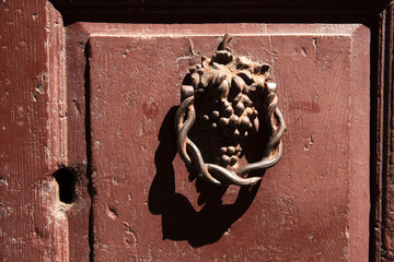 Montemerano (GR), Italy - September 11, 2017: An old knocker on a door in Montemerano village,...