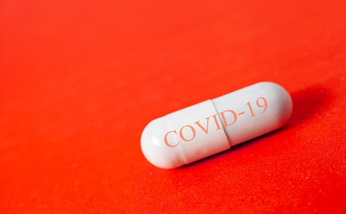 Obraz na płótnie Canvas Capsule pill Medicine Positive Coronavirus or COVID-19.Medicine Of viruses in laboratory for Prevention of a pandemic in Wuhan China. scientist in biological protective Epidemic virus outbreak concept