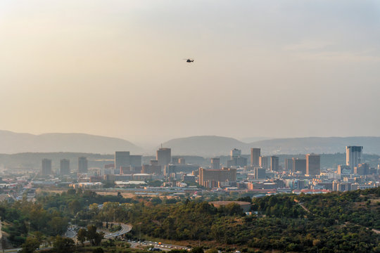 Pretoria skyline with helicopter above skyscrapers, capital city of South Africa